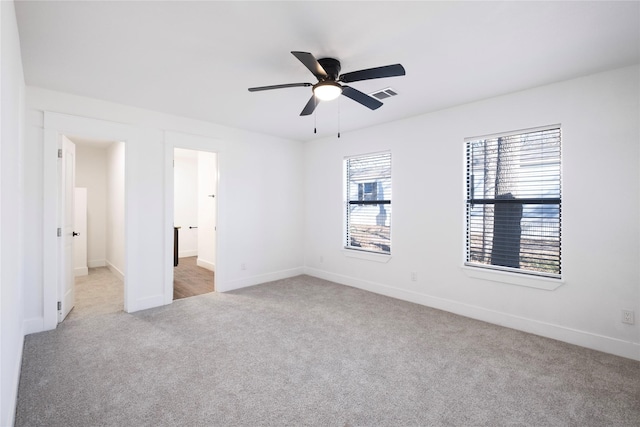 interior space featuring visible vents, baseboards, and a ceiling fan