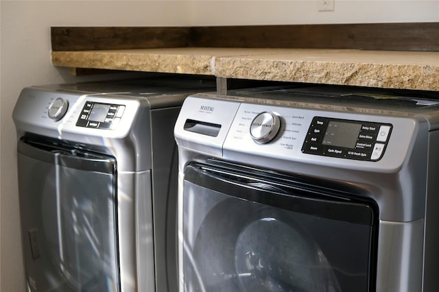 washroom with independent washer and dryer and laundry area
