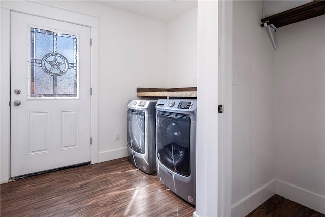laundry area with laundry area, dark wood-style flooring, baseboards, and washing machine and dryer