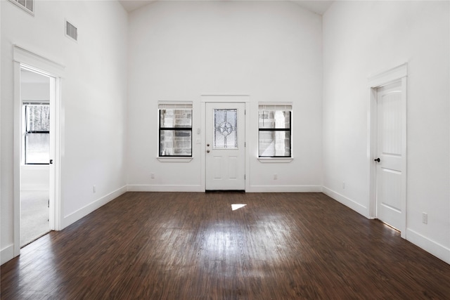foyer featuring high vaulted ceiling, plenty of natural light, and visible vents