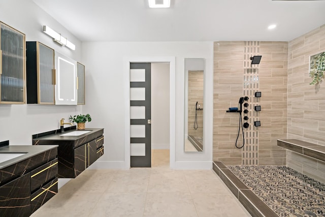 9035 Leaside Dr, Dallas, TX 75238 - bathroom with tile patterned flooring, a walk in shower, two vanities, baseboards, and recessed lighting