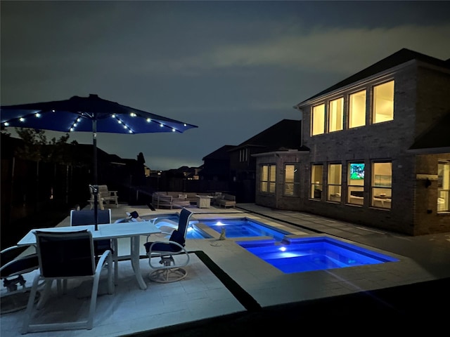 5841 Willow Ln, The Colony, TX 75056 - pool at twilight with an in-ground hot tub, an outdoor hangout area, and a patio area