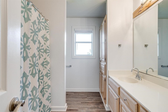 bathroom featuring baseboards, a shower with curtain, vanity, and wood finished floors
