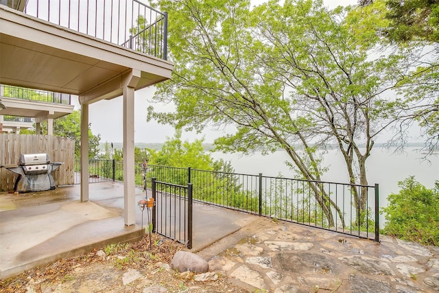 view of patio / terrace featuring fence and a grill