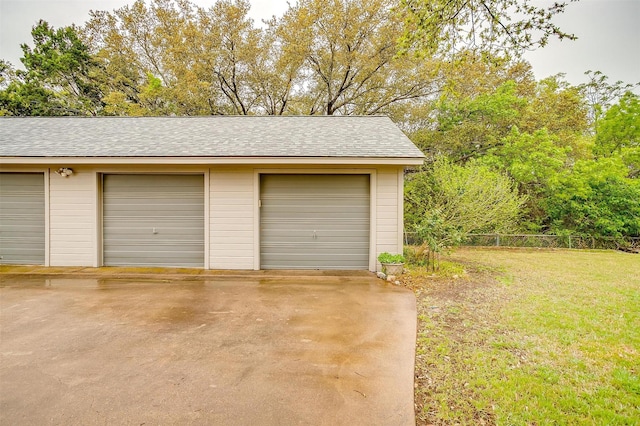 detached garage featuring fence