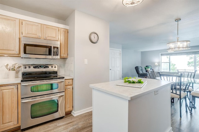 kitchen with light countertops, light wood-style floors, light brown cabinetry, and stainless steel appliances