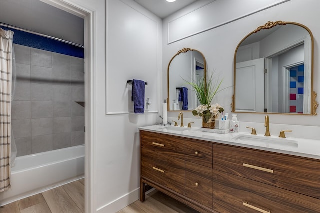 604 Grand Falls Ln, Mckinney, TX 75071 - bathroom featuring double vanity, shower / bath combination with curtain, baseboards, and wood finished floors