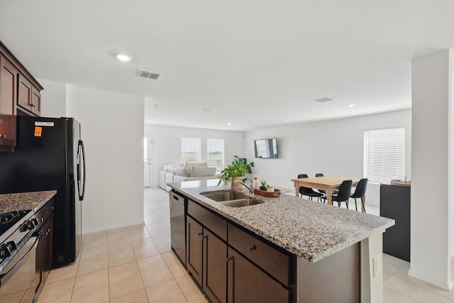 6436 Auburn Dale Rd, Pilot Point, TX 76258 - kitchen with a sink, dishwasher, an island with sink, gas range, and light stone countertops