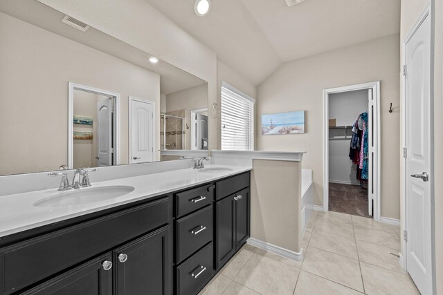 bathroom with tile patterned floors, a sink, double vanity, and visible vents