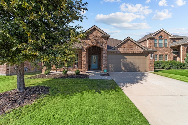 view of front facade with brick siding, a garage, concrete driveway, and a front yard