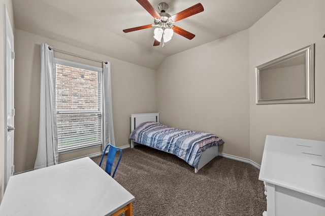 bedroom featuring baseboards, lofted ceiling, and dark carpet