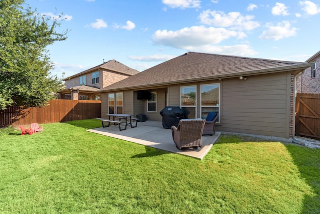 back of property with roof with shingles, a lawn, fence, and a patio area