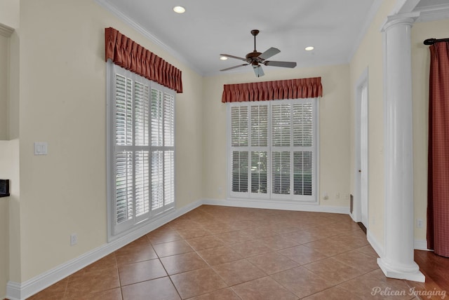 unfurnished room with a ceiling fan, crown molding, tile patterned floors, and decorative columns