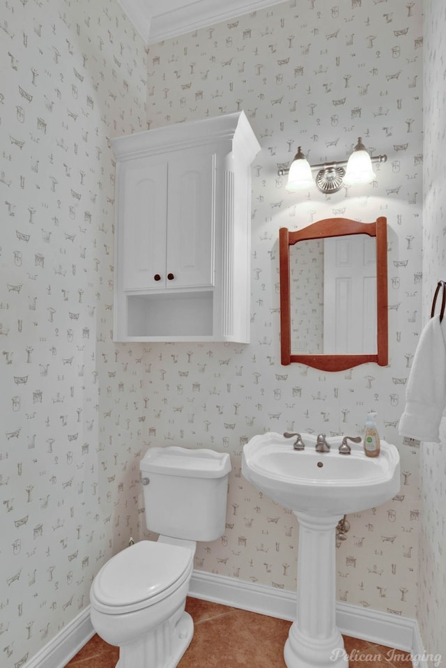 half bathroom with baseboards, wallpapered walls, and tile patterned floors
