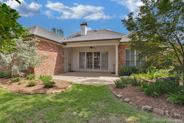 rear view of house featuring brick siding, a lawn, a patio area, and ceiling fan