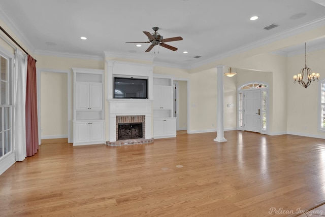 unfurnished living room featuring a brick fireplace, ornamental molding, ceiling fan with notable chandelier, visible vents, and light wood-style flooring