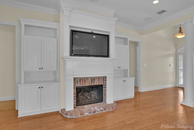 unfurnished living room with light wood finished floors, a brick fireplace, baseboards, visible vents, and ornamental molding