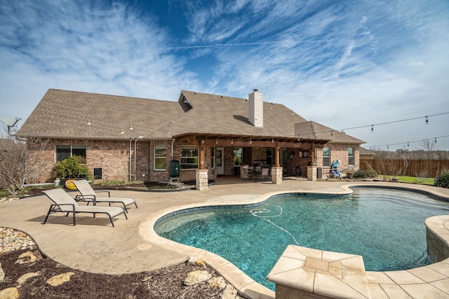 view of swimming pool with fence, outdoor dry bar, a patio area, and a fenced in pool