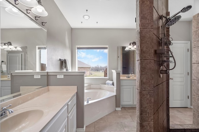 bathroom featuring a bath, a sink, tile patterned floors, and two vanities