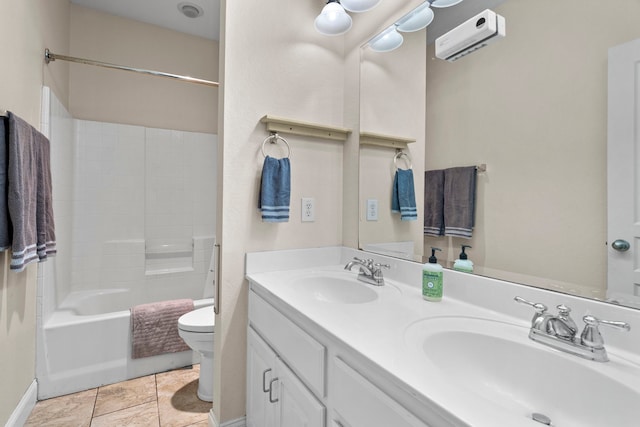 bathroom with double vanity, toilet, an AC wall unit, and a sink