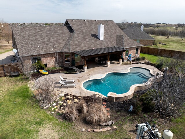 view of swimming pool featuring a lawn, a fenced in pool, a fenced backyard, and a patio area