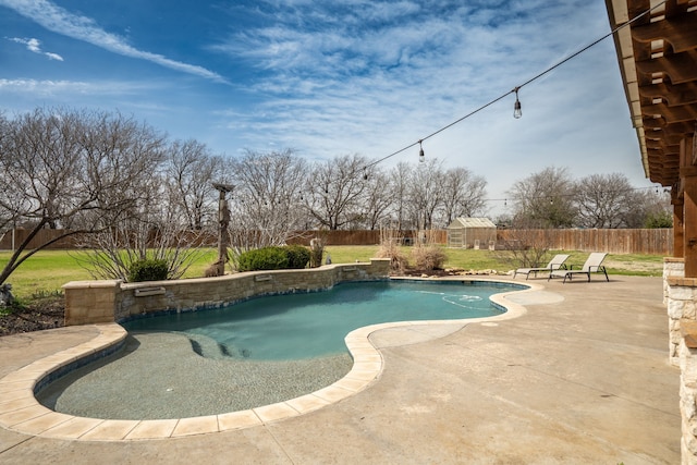 view of pool with a fenced backyard, an outbuilding, a patio area, and a fenced in pool