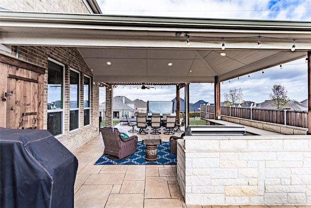 view of patio / terrace with a fenced backyard, outdoor dry bar, and area for grilling