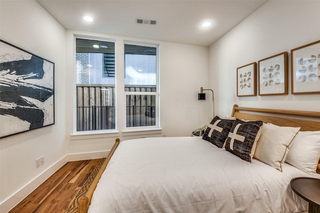 426 W 9th St Unit 105, Dallas, TX 75208 - bedroom with baseboards, recessed lighting, wood finished floors, and visible vents