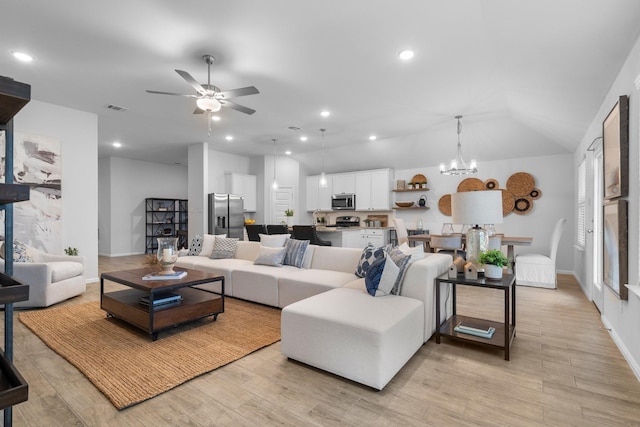 3708 Bluestem Blvd, Denton, TX 76226 - living room with ceiling fan, light wood-style floors, a chandelier, recessed lighting, and lofted ceiling