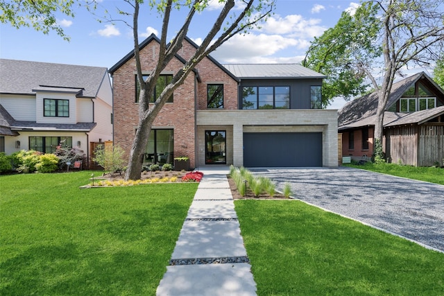 tudor home with brick siding, driveway, a front lawn, and a garage