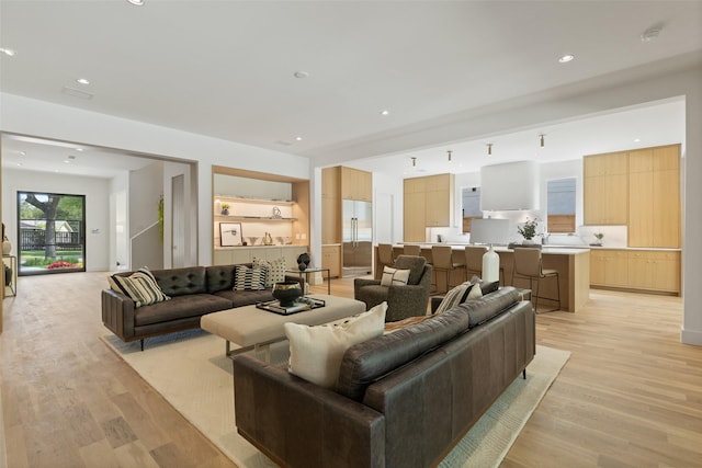 living room with light wood-style floors and recessed lighting
