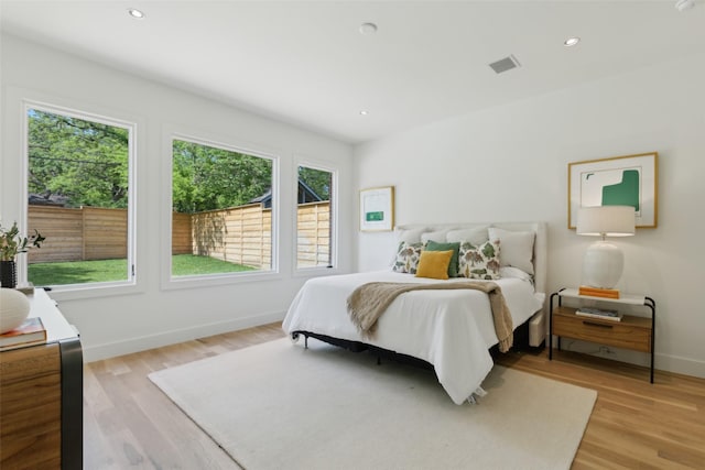 bedroom featuring visible vents, recessed lighting, light wood-style floors, and baseboards