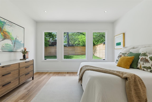 bedroom featuring multiple windows, recessed lighting, and light wood-style flooring