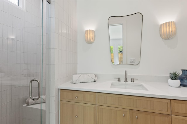 full bath with a healthy amount of sunlight, vanity, and a shower stall