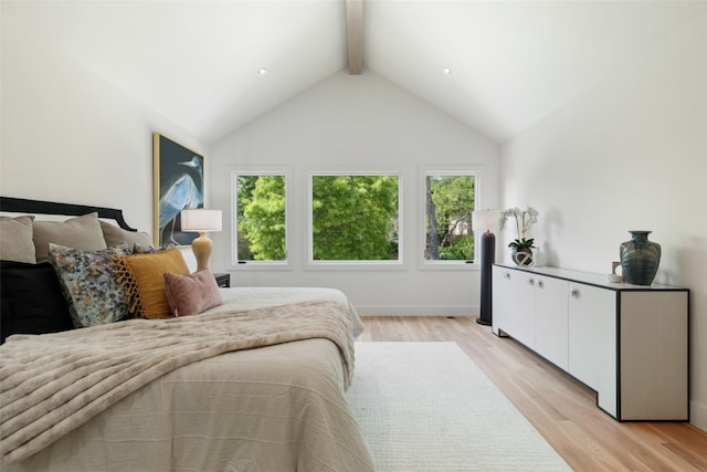 bedroom featuring light wood-style floors and lofted ceiling with beams