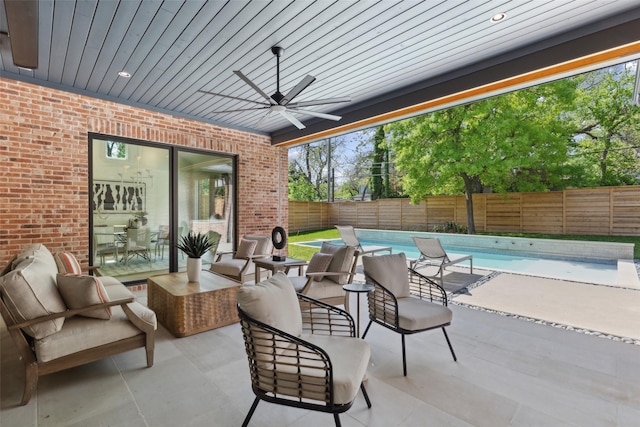 view of patio / terrace featuring a fenced in pool, a ceiling fan, and a fenced backyard