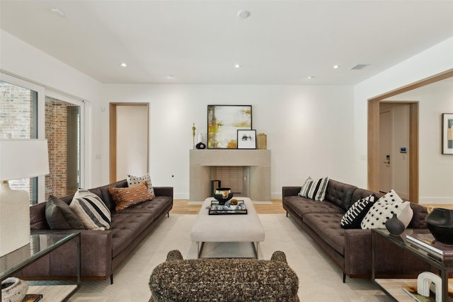 living room with recessed lighting, visible vents, and a fireplace