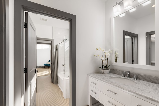 bathroom featuring  shower combination and vanity