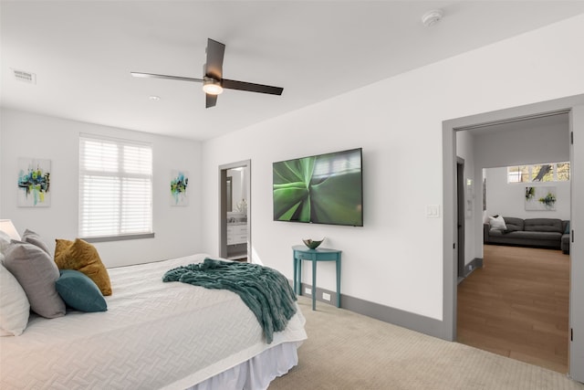 bedroom with baseboards, visible vents, multiple windows, and a ceiling fan