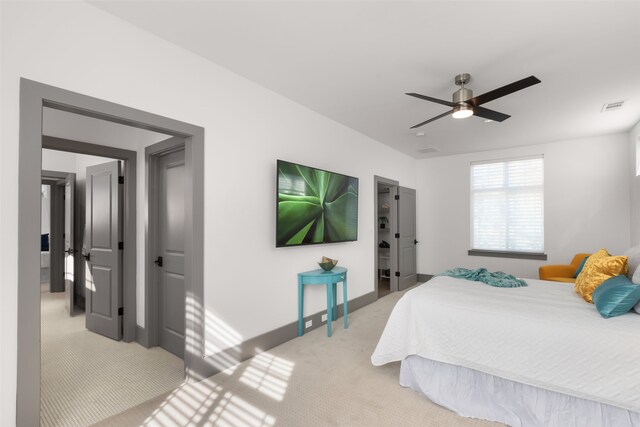 bedroom featuring baseboards, ceiling fan, visible vents, and light carpet