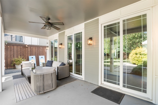 view of patio / terrace featuring an outdoor living space, fence, and a ceiling fan