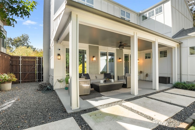 view of patio with an outdoor hangout area, fence, and a ceiling fan