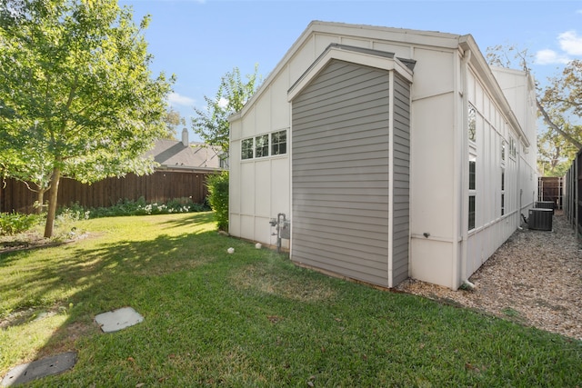 view of outdoor structure with a fenced backyard and central AC