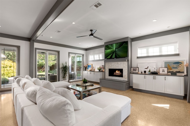 living room featuring a lit fireplace, ceiling fan, visible vents, and recessed lighting