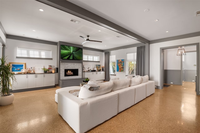 living room featuring a large fireplace, visible vents, ceiling fan, and recessed lighting