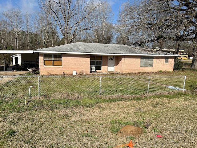 view of front of home with fence private yard, brick siding, an attached carport, and a front lawn