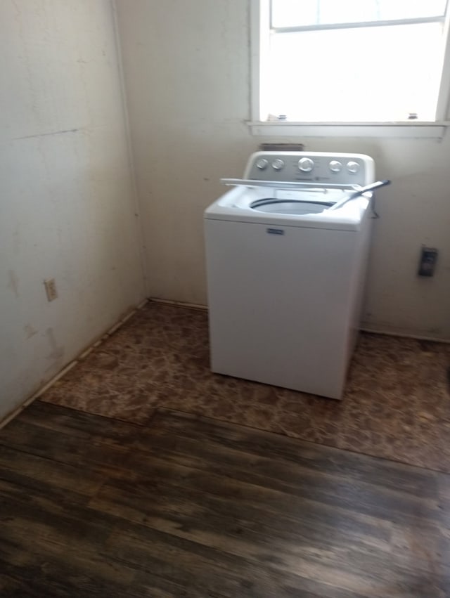 washroom featuring dark wood-type flooring, laundry area, and washer / dryer