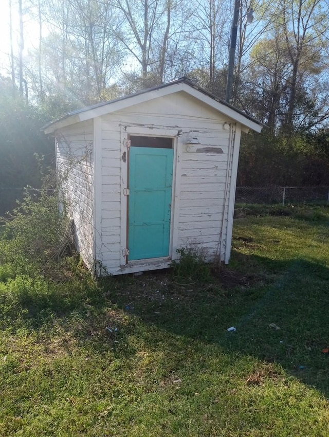 view of shed featuring fence
