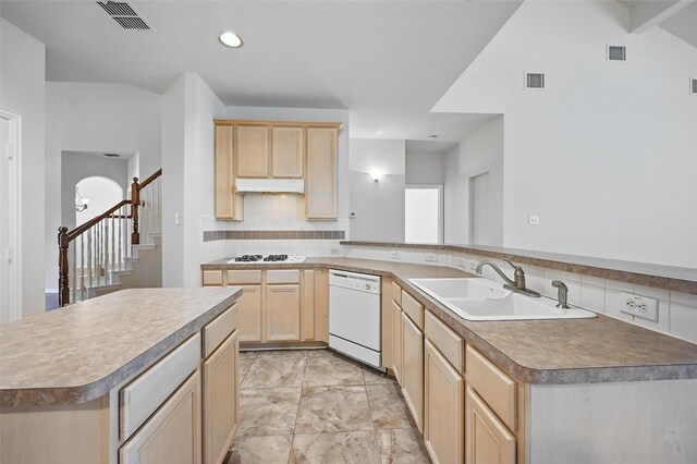 kitchen featuring a sink, light brown cabinetry, visible vents, and white appliances