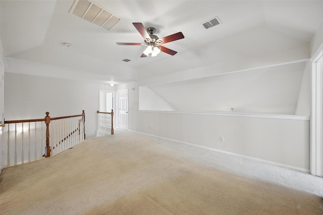 additional living space with a ceiling fan, carpet, vaulted ceiling, and visible vents